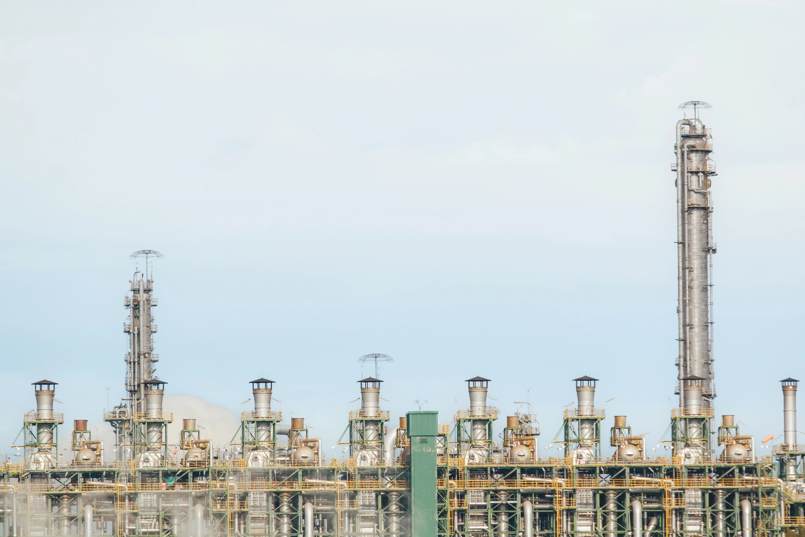 Industrial refinery and plant infrastructure under blue sky